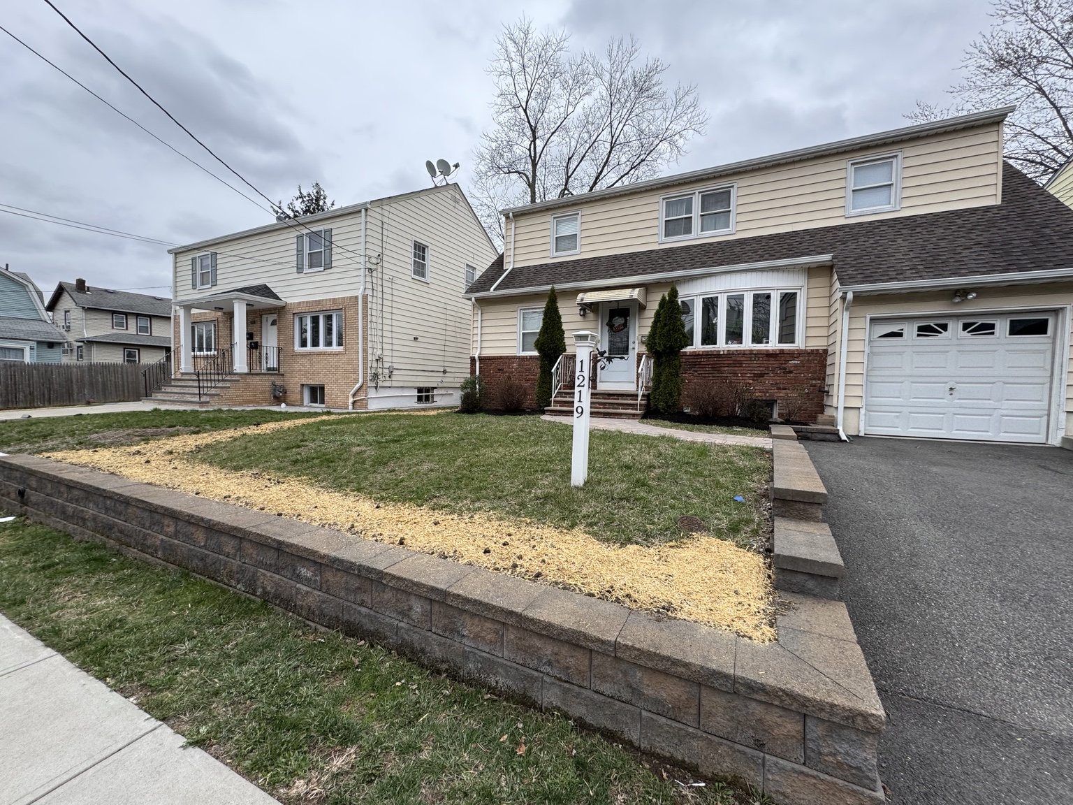Front lawn repair with straw-covered areas
