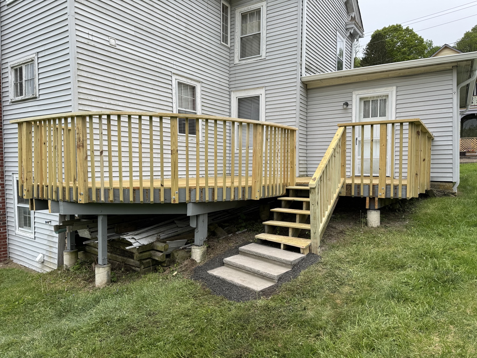 Refaced deck with updated wooden railings and stairs